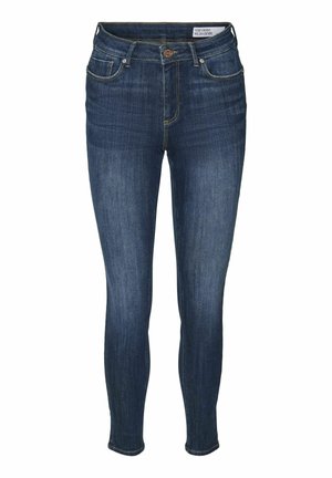 Tievās džinsos no tumši zila denima, ar augsto jostasvietu, piecām kabatām un zelta šuvēm. Klasisks dizains, šaura piegriezuma veids.