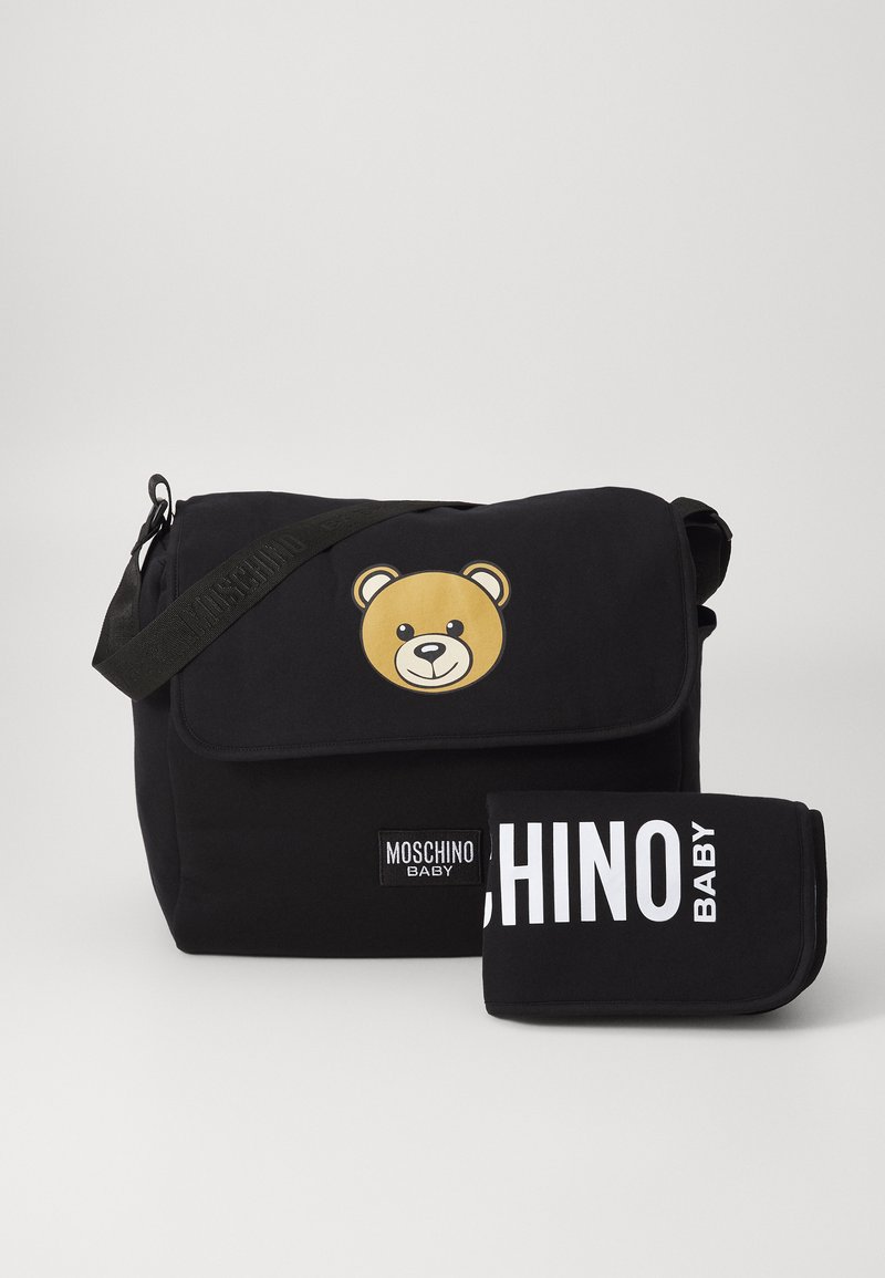 Black messenger bag made of fabric, featuring a large bear design on the flap and a folded accessory with "MOSCHINO BABY" text.