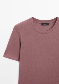Short-sleeve, crew neck t-shirt in muted mauve, made of soft cotton. Features a plain texture and small brand label at the neckline.