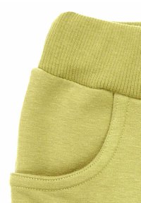 Jasnozielona tkanina z prążkowanym pasem, wyposażona w boczną kieszeń. Miękka tekstura i casualowy design, odpowiednie do wygodnego noszenia.