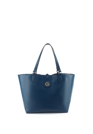 Marineblaue Leder-Tragetasche mit zwei Griffen und einem runden goldfarbenen Logo-Emblem, das zentriert unterhalb der Öffnung angebracht ist.