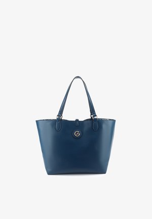 Marineblaue Leder-Tragetasche mit zwei Griffen und einem runden goldfarbenen Logo-Emblem, das zentriert unterhalb der Öffnung angebracht ist.
