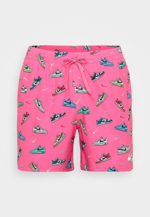 Pink swim shorts featuring various sneaker designs in multiple colors. Includes an elastic waistband with a drawstring for adjustable fit.