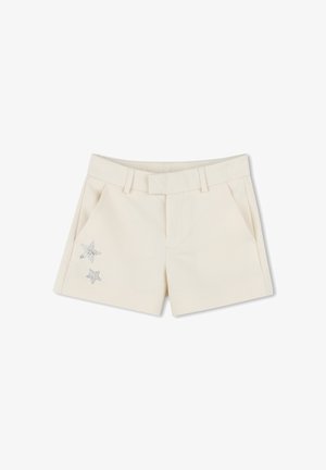 Shorts crème avec une texture lisse, présentant deux poches avant et des accents de étoiles en rhinestones décoratifs sur la poche gauche.