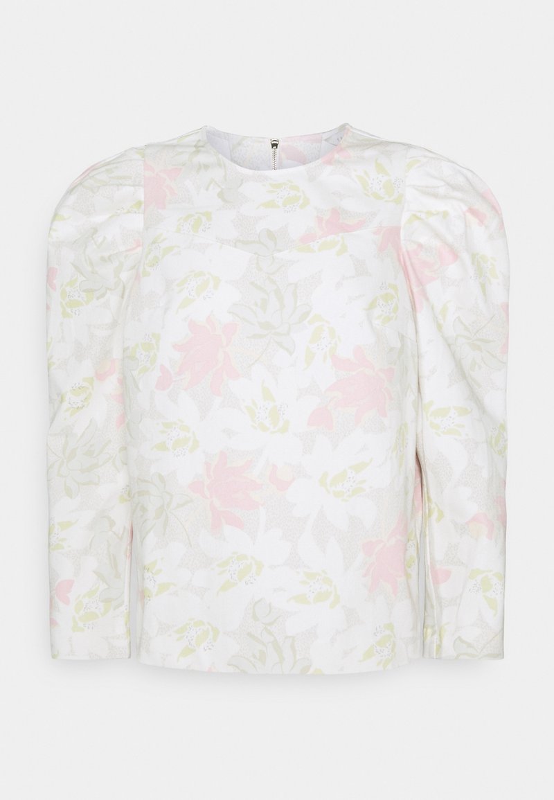 Blouse blanche à manches longues avec un subtil motif floral pastel et épaules bouffantes, dotée d'une fermeture éclair au dos.