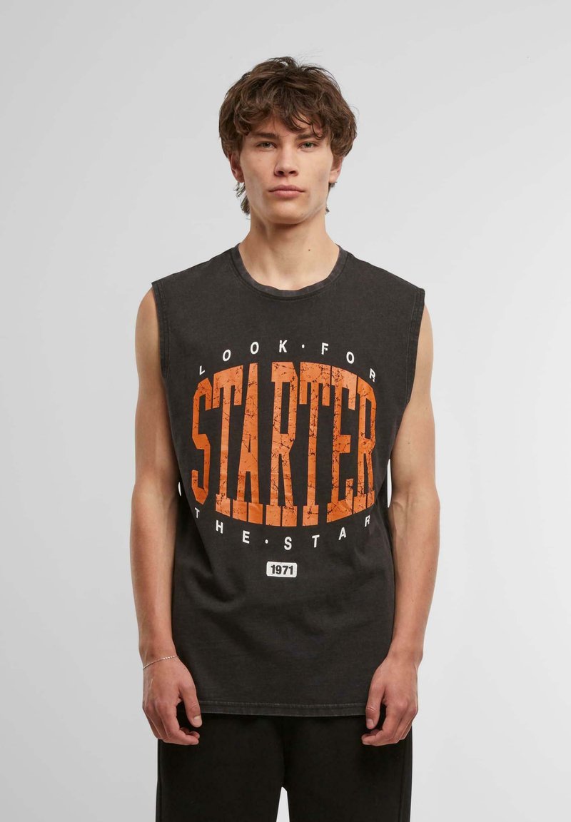 Sleeveless black graphic tank top featuring a large orange "STARTER" print, with a textured finish and crew neckline. Cotton material.