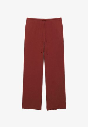 Pantalon large couleur rouille avec taille élastique et cordon de serrage à l'avant, fabriqué en tissu texturé.