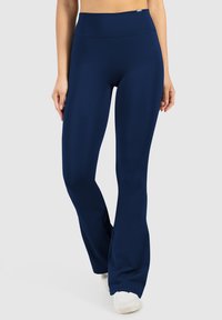 Leggings da allenamento a campana di colore navy, realizzati in un tessuto elastico, con una vita alta e una superficie liscia. Design semplice senza motivi visibili.