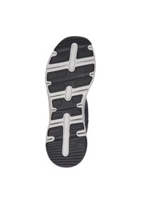 Suela de zapatilla deportiva negra con goma gruesa, patrones texturizados y detalles blancos. Secciones elevadas para tracción y estabilidad.