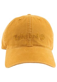 Yellow cotton baseball cap featuring embroidered "Timberland" logo and tree emblem. Soft texture with a curved brim and adjustable back strap.