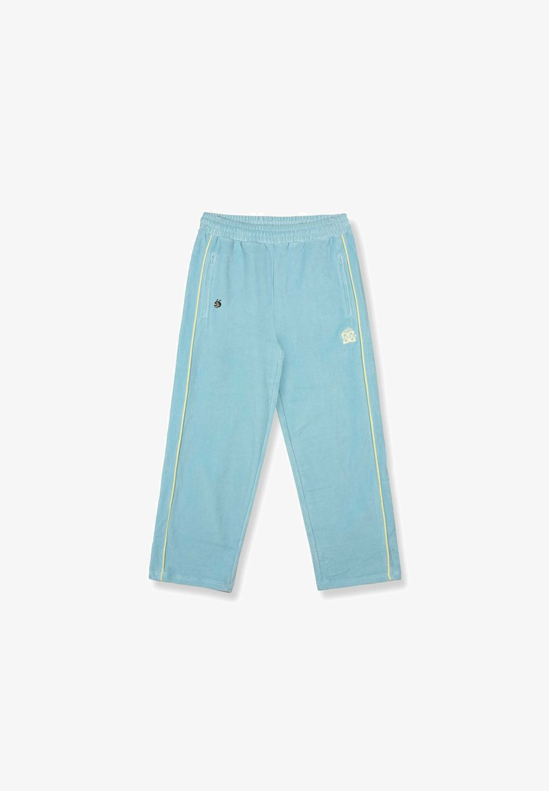 Hellblaue Jogginghosen mit elastischem Bund, seitlichen Reißverschlusstaschen und gelben Paspeln an den Beinen, die kleine weiße und schwarze Logos aufweisen.
