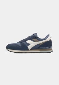 Navy and white athletic shoes made of mesh and suede. Features a rounded toe, lace-up front, and a cushioned sole with subtle branding.