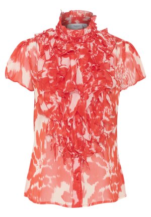 Punane ja valge volangiga pluus lühikeste varrukatega, kõrge kaelusega ja nööpidega. Valmistatud kergest, läbipaistvast kangast, millel on tekstuuriline muster.