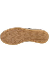 Gum rubber sole with herringbone tread pattern. White upper with blue and red accents. Smooth texture with minimal detailing. Round logo at heel.