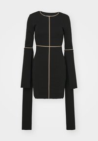 Svart långärmad klänning med en figursydd silhuett, guldtråd längs sömmarna och utsvängda ärmar som sträcker sig förbi handleden.