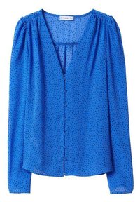 Blouse bleue à manches longues, encolure en V et fermeture boutonnée à l'avant. Tissu léger et texturé avec de petits pois noirs.