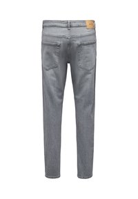 Achteraanzicht van grijze slim-fit denim jeans met twee achterzakken en een bruin leren merklabel op de tailleband.