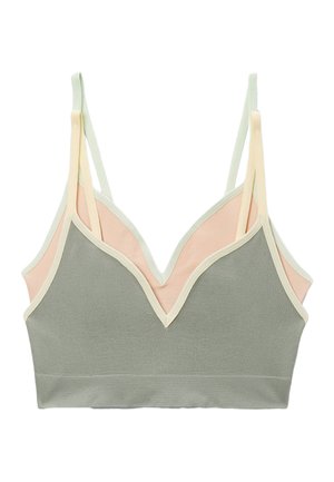 Bralette côtelée douce avec double bretelles fines, présentant des panneaux avant vert sauge et arrière pêche pâle, bordée d'un liseré blanc cassé.