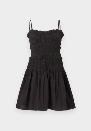 Μαύρο αμάνικο φόρεμα με λεπτές τιράντες, σμιλευμένο μπούστο με λεπτομέρειες βολάν και φαρδιά φούστα.