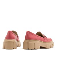 Scarpe slip-on in pelle rosa con suola chunky beige, caratterizzate da bordi arrotondati e cuciture minime, che offrono una finitura testurizzata.