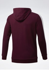Felpa bordeaux con cappuccio regolabile, maniche lunghe e strisce bianche sui lati. Tessuto in morbido cotone misto, polsini e orlo a coste.