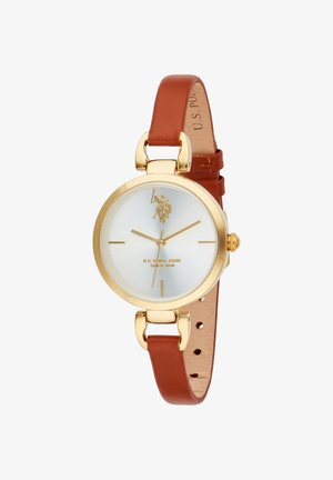 Orologio da polso color oro con quadrante bianco, cinturino in pelle marrone e cassa in metallo lucido. Dettagli distintivi includono un logo e indicatori delle ore minimalisti.