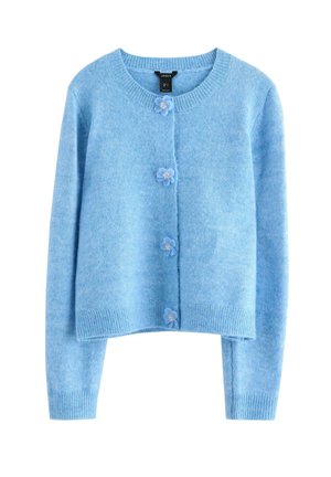 Lyseblå strikket cardigan med rund hals, fem knapper med blomsterdetaljer og lange ærmer. Blød tekstur og cropped design.