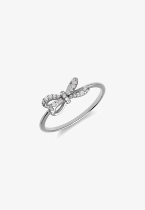 Silver ring featuring a bow design adorned with small clear gemstones, creating a shimmering effect on a smooth band.