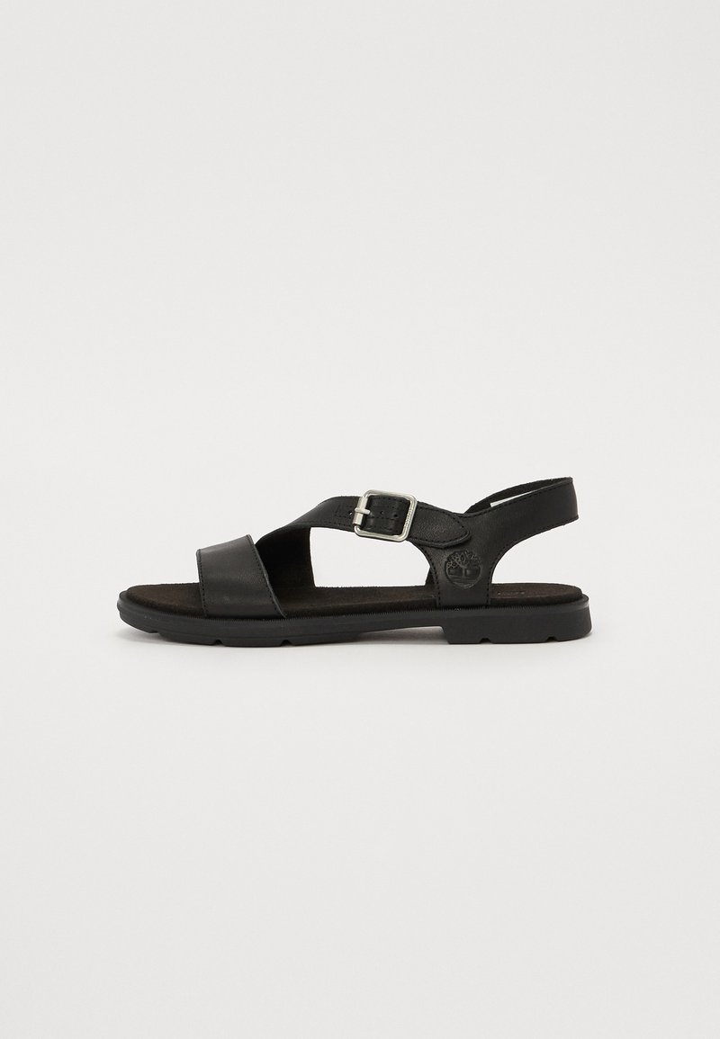 Sandalho de couro preto com um design de tiras cruzadas, fivela ajustável, sola acolchoada e palmilha texturizada. Logotipo visível na lateral.