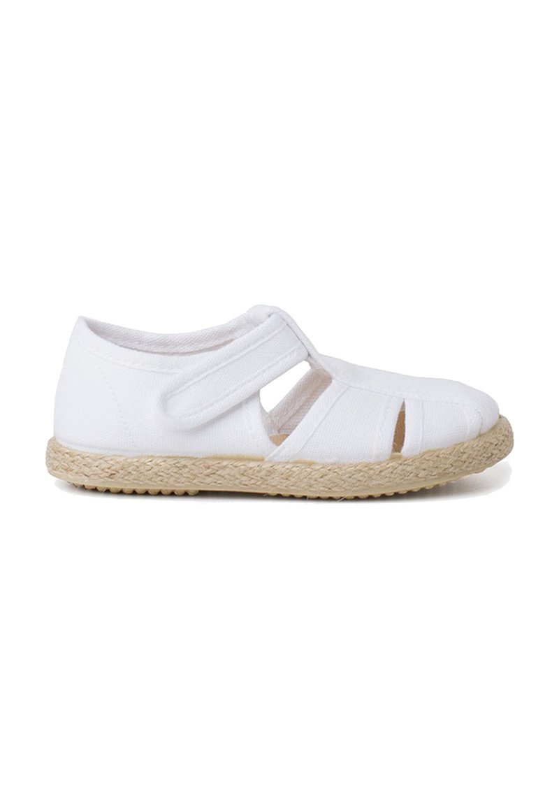 White canvas shoe with a woven jute sole, featuring cutouts and a Velcro strap for easy fastening. Smooth texture, casual design.