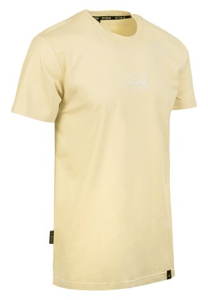 Light yellow cotton t-shirt with a crew neck, short sleeves, and a white logo printed on the front. Features a tag on the lower side.