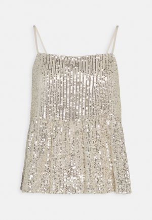 Lesklý top s tenkými ramínky, s nařaseným peplum designem ve zlatých a stříbrných odstínech. Hladká textura s reflexními povrchy.