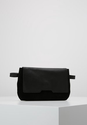 Sort clutchtaske lavet af læder og ruskind, med flaplukning, rektangulær form og et lille hanke på siden. Glatte og teksturerede detaljer.