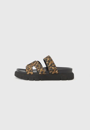 Leopard print slide sandal with two wide straps, black rubber sole, and a textured upper. Features a chunky, grooved outsole.