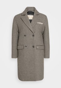 Abrigo de doble botonadura en un patrón de cuadros marrón y beige. Tejido de mezcla de lana con solapas con muescas, dos bolsillos frontales y detalles de botones.