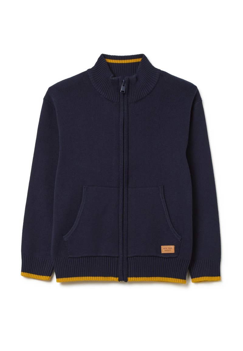 Marineblaue Strickjacke mit hohem Kragen, Reißverschluss, zwei Fronttaschen und gelben Akzenten am Saum und Kragen. Etikett mit Markenlabel.