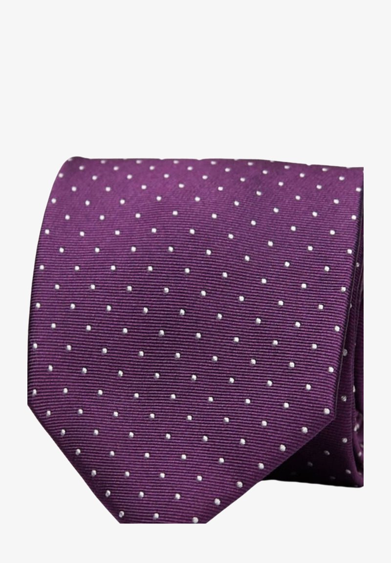 Lila slips med vita prickar, med en texturerad tyg och en spetsig topp. Designen är jämnt fördelad över ytan.