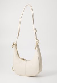 White leather handbag with a curved shape, featuring a woven shoulder strap, gold hardware, and a zip closure. Textured surface with seams.
