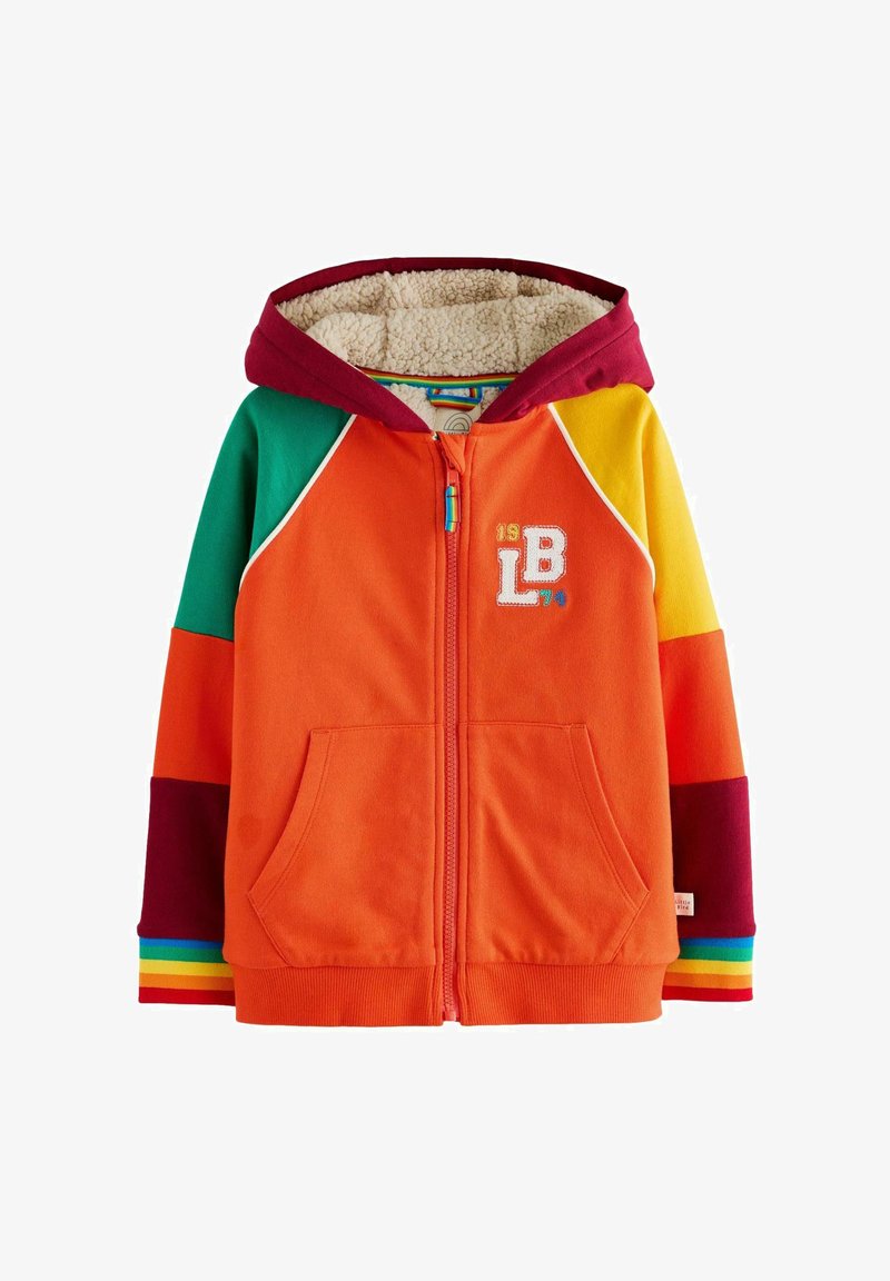 Farebná mikina na zips s oranžovým telom, marhuľovou kapucňou, tyrkysovými a žltými rukávmi a manžetami s dúhovým prúžkovaním. Podšitá mäkkým, textúrovaným materiálom.