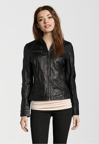 Black leather jacket with a fitted design, zippered front, and quilted accents at the hem and shoulders. Long sleeves and smooth texture.