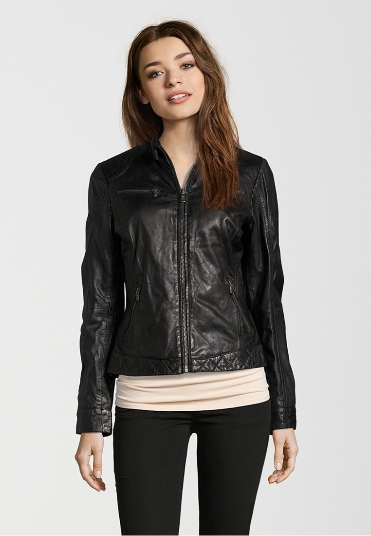 Black leather jacket with a fitted design, zippered front, and quilted accents at the hem and shoulders. Long sleeves and smooth texture.