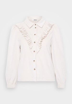 Camisa de botão bege claro com detalhes plissados na frente, botões em tom dourado, mangas longas e colarinho estruturado.