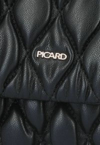 Black quilted leather bag featuring a textured pattern and a metallic PICARD logo. Smooth finish with pronounced stitching details.