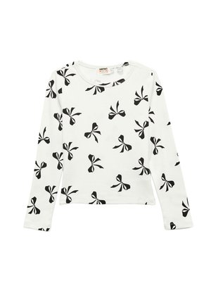 Chemise blanche à manches longues en coton avec un motif de nœuds noirs, encolure ronde et ourlet droit. Texture douce, coupe décontractée.