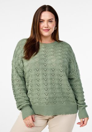 Light green knitted sweater featuring a wave pattern, ribbed cuffs and hem, and a loose fit. Textured fabric enhances visual interest.