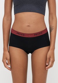 Černé hipsterské spodní prádlo s třpytivým vínovým pasem, na kterém je nápis "PIECES". Vyrobeno z hladké, pružné látky.