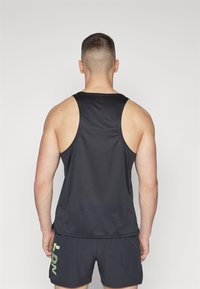 Black sleeveless tank top with a smooth texture, featuring a round neck and wide armholes, paired with matching black shorts.