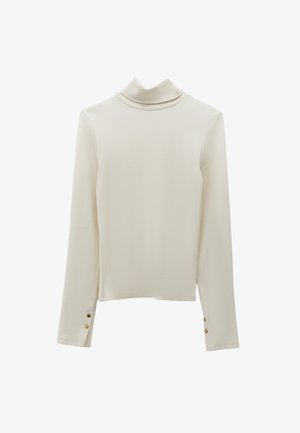 Crème coltrui met gebreide textuur en lange mouwen. Kenmerkt zich door goudkleurige knoopaccenten op de manchetten.