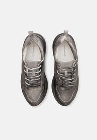 Gray mesh and leather shoes with a rounded shape, textured upper, and gray laces. Features a thick black sole for support.