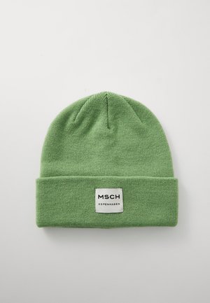 Green knitted beanie with a folded cuff. Tag displays "MSCH COPENHAGEN" in black on a white background. Soft texture and seamless design.